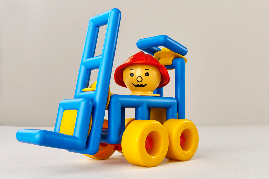 Toy figure with a blue forklift and yellow wheels on a light gray background