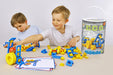 Two children playing with a toy construction set on a table, with a container labeled 'Mobiloo' in the background.